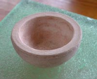 a ceramic bowl on a glass table